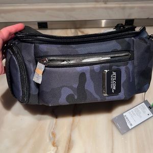 Tumi sling bravo- navy camp.  Brand new- new used.  Men’s or women’s